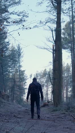 man hiking through a frozen forest