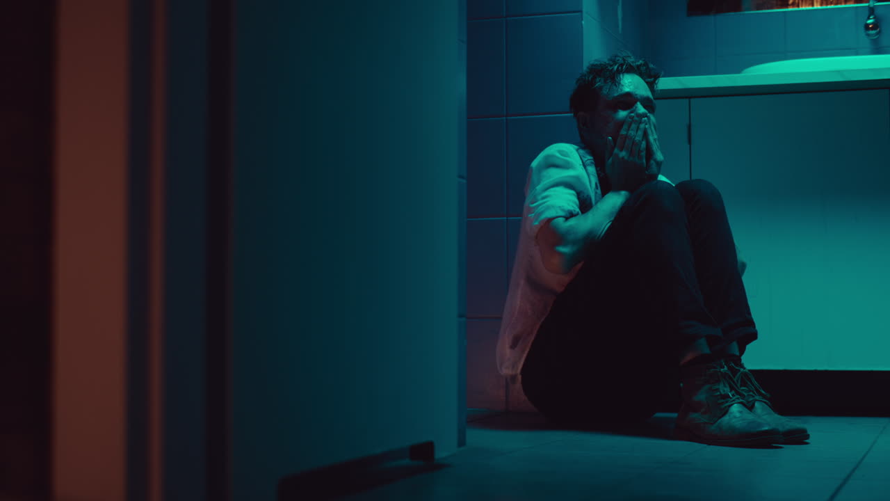 Man Crying in a Bathroom