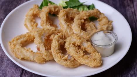 cooked squid rings and shrimp on a plate top view ,