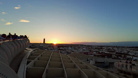 Shot-of-tourists-watching-sunrise-from-Las-Setas-de-Sevilla,-also-known-as-Metropol-Parasol,-Seville-in-Spain-at-dawn