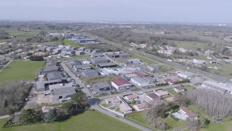 Warehouses-in-the-rural-town-of-Montussan-France-in-the-southwest,-Aerial-flyover-shot