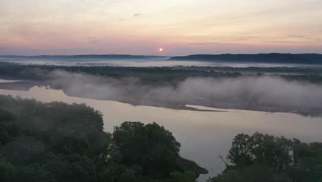 misty sunrise over river valley