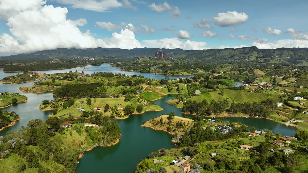 Aerial tracking shot overlooking nature of the Pe&ntilde;ol-Guatap&eacute; Reservoir in Colombia