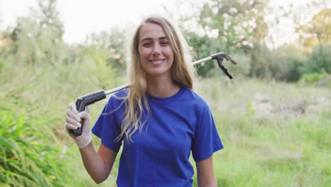 Caucasian-woman-smiling-and-looking-at-camera-during-river-clean-up-day