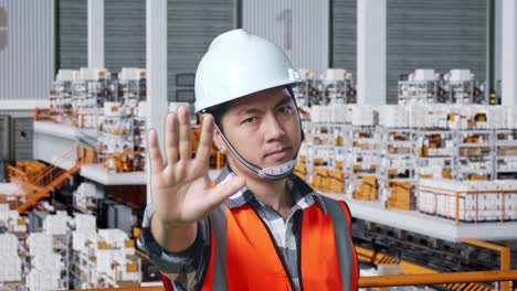 warehouse worker giving stop gesture