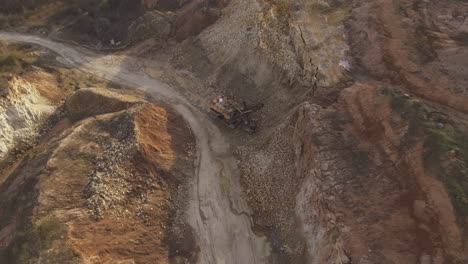 flight towards a giant walking excavator stands in an excavated quarry