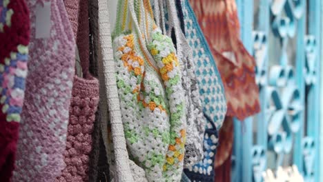 colorful crocheted and knitted bags on display