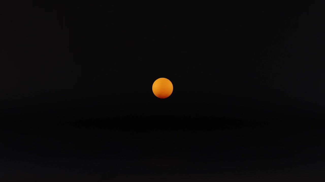 A tennis ball moves against a dark background