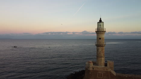 lighthouse in port with sunset