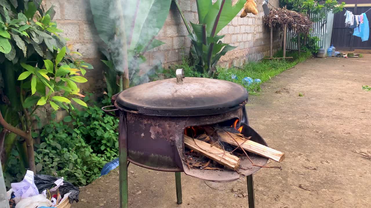 Ethiopian cooking pan for enjera working with smoke and flames outdoor poor house