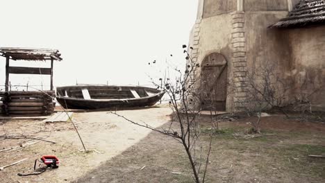 old abandoned village scene with wooden boat