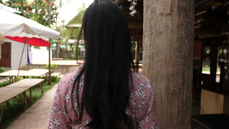 woman standing outdoors in a restaurant/cafe