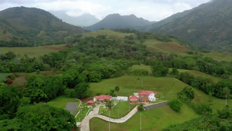 Hermosa-Vista-De-Una-Casa-En-El-Campo-Entre-Las-Montañas-Verdes,-Con-Vistas-A-Un-Cielo-Increíble