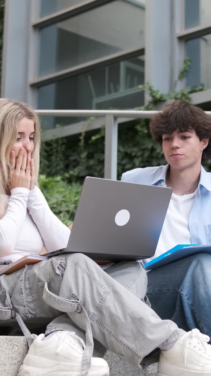 Students receiving bad news on laptop computer
