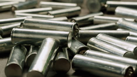 silver batteries aa and aaa on black background close-up. double-a battery is a standard size single cell cylindrical dry battery. batteries are common in portable electronic devices. an aa battery is composed of a single electrochemical cell that may be either a primary battery or a rechargeable ba