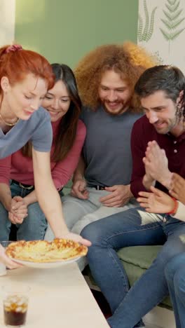 Friends at home delighted with the good smell of pizza