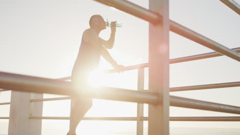 senior man drinking water on the promenade