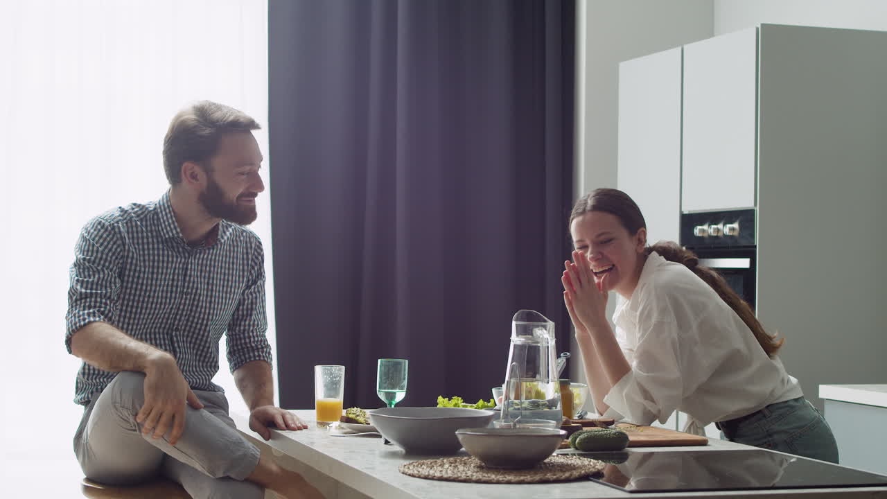 Cheerful Couple Spending Good Time Together In A Modern Style Kitchen