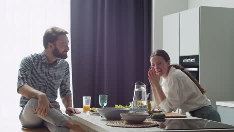 cheerful couple spending good time together in a modern style kitchen