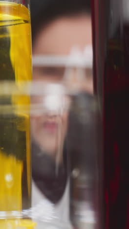 blurry lady lab assistant puts test tube with red liquid sample on rack in hospital slow motion. probe lens footage of medical researching macro view