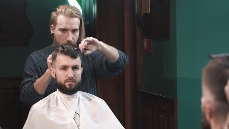 barber cutting a man's hair in a barbershop