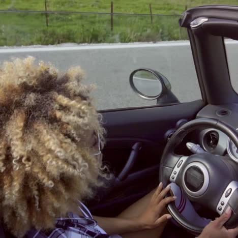 young woman driving a cabriolet