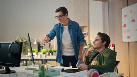 inspired creators pointing computer screen at office. team planning strategy