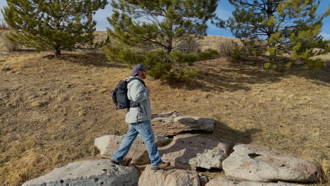 Caucasian-man-with-backpack-hiking-stops-to-enjoy-the-view-in-Colorado