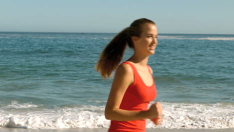 happy woman running on the beach