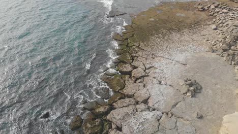 aerial view of cracked rocky coastline beside gulf of oman in jiwani