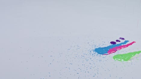 various colors are dripping on a white background.