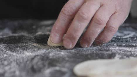 making meat dumpling with wooden rolling pin.