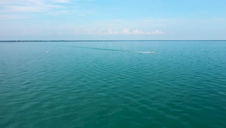 Boats-cruising-across-open-water-on-sunny-summer-day