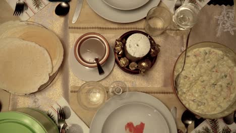 overhead left slow motion slide over richly decorated christmas dinner table