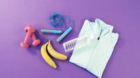 banana, skipping rope, dumbbells, water bottle and zipper