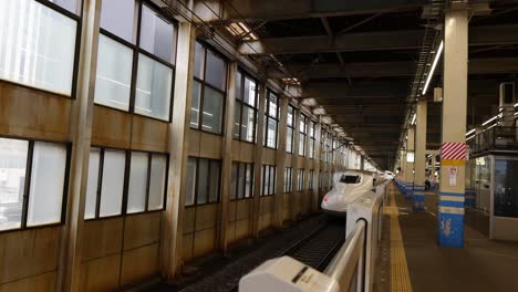 bullet train pulling into a modern train station