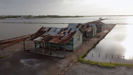 flight backwards in the salt mine in bani, peravia province, at dusk with a view of a blue car at the end of the clip