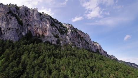 wide shot of majestic karts limestone mountains on a summer day