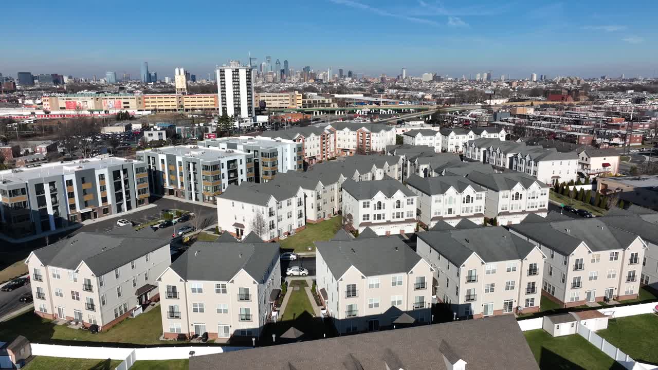 Apartment condo building complex in USA with urban skyline in distance