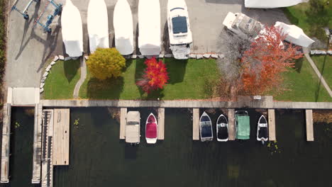 Top-down-aerial-view-luxury-expensive-boats-and-yachts-docked-in-harbour