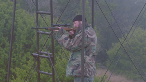 Right-wing-extremist-holding-up-gun-while-smoking-in-redneck-outpost