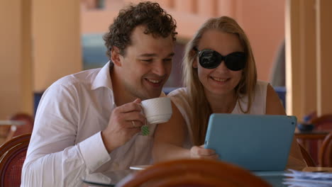 loving couple in cafe with touchpad