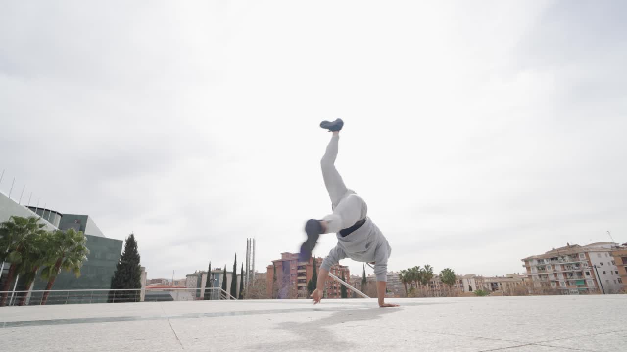 Breakdancer performing acrobatics in urban environment