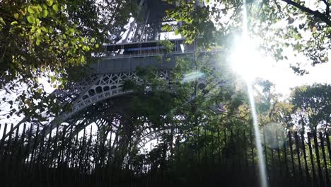 Walking-And-Passing-To-The-Famous-Eiffel-Tower-On-A-Sunny-Morning-In-Paris,-France