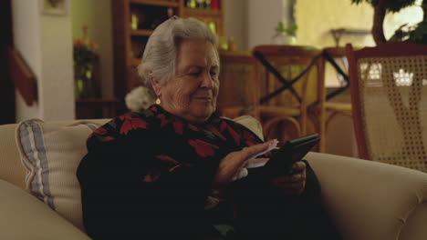 elderly woman reading digital book