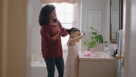 happy mother brushing daughters hair in bathroom cute little girl getting ready in morning loving mom enjoying parenthood caring for child