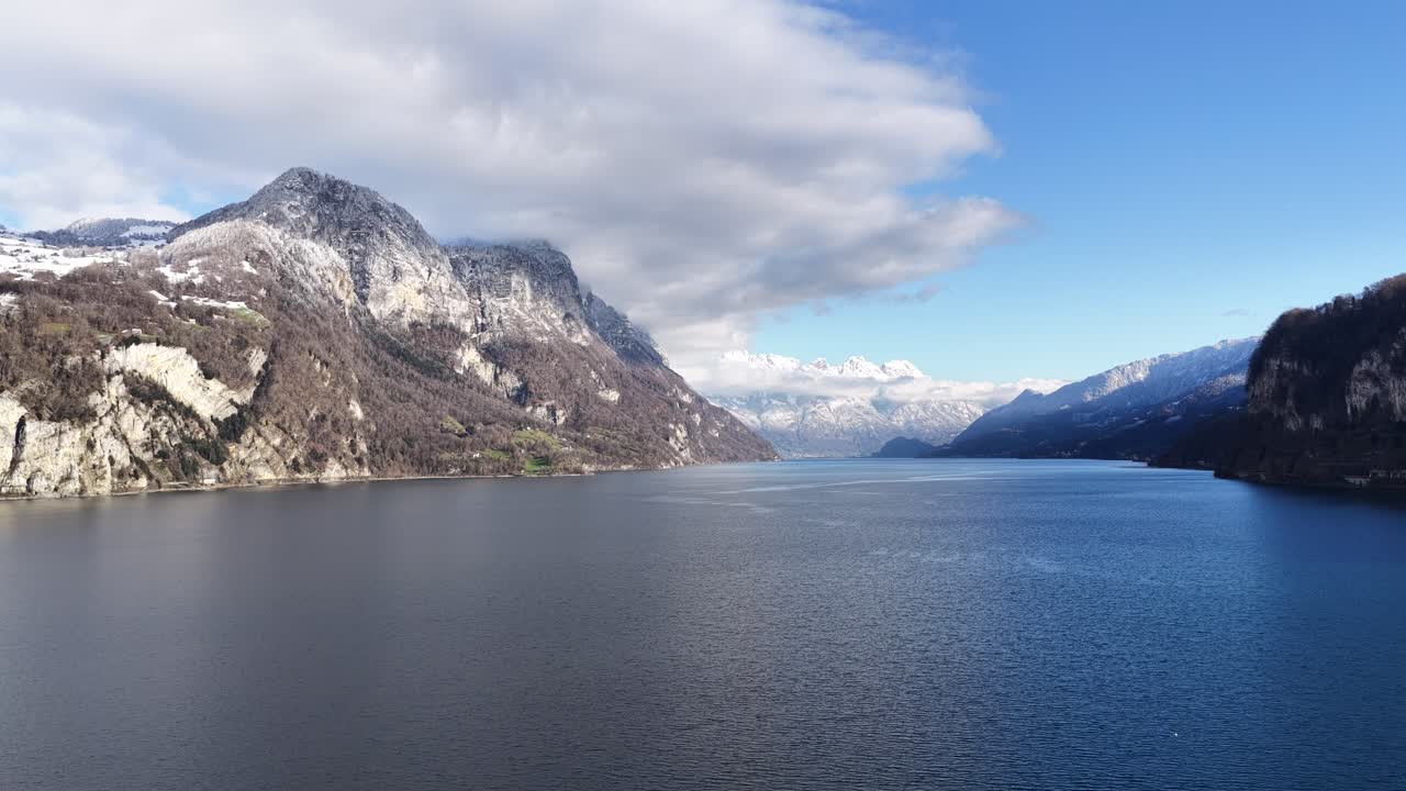 Walensee, Switzerland drone view over calm blue lake, alpine mountains and winter peaks, peaceful Europe nature landscape and clean environment