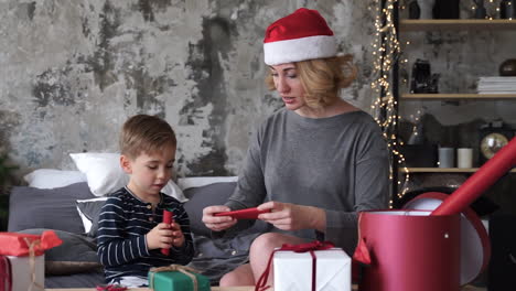 mother and son prepare christmas gifts