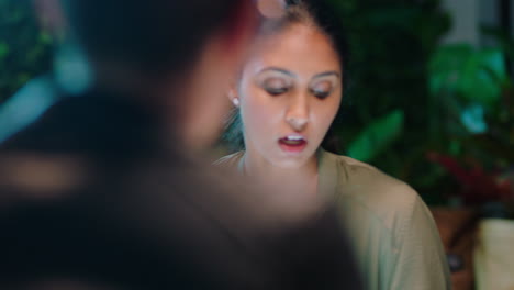 young-indian-business-woman-working-late-colleagues-brainstorming-creative-ideas-discussing-project-deadline-collaborating-planning-successful-strategy-in-trendy-startup-office-workspace