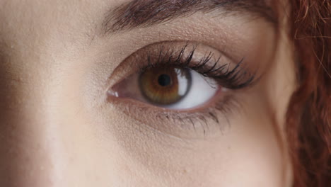 close-up-of-young-woman-eye-looking-at-camera-blinking-pensive-contemplative-beautiful-detail-feminine-beauty